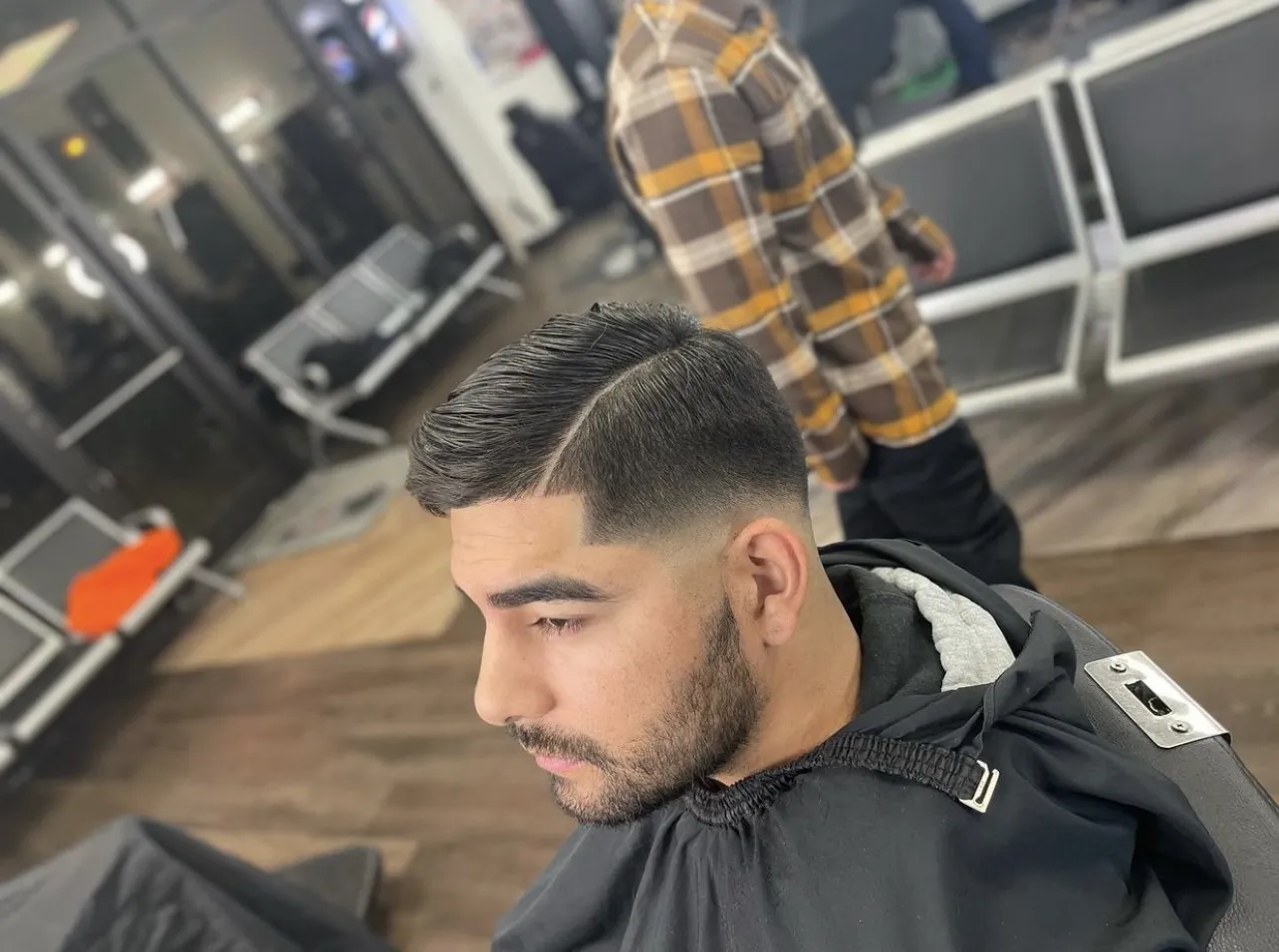 Mid fade with a textured top at VIP Barber Lounge Denver