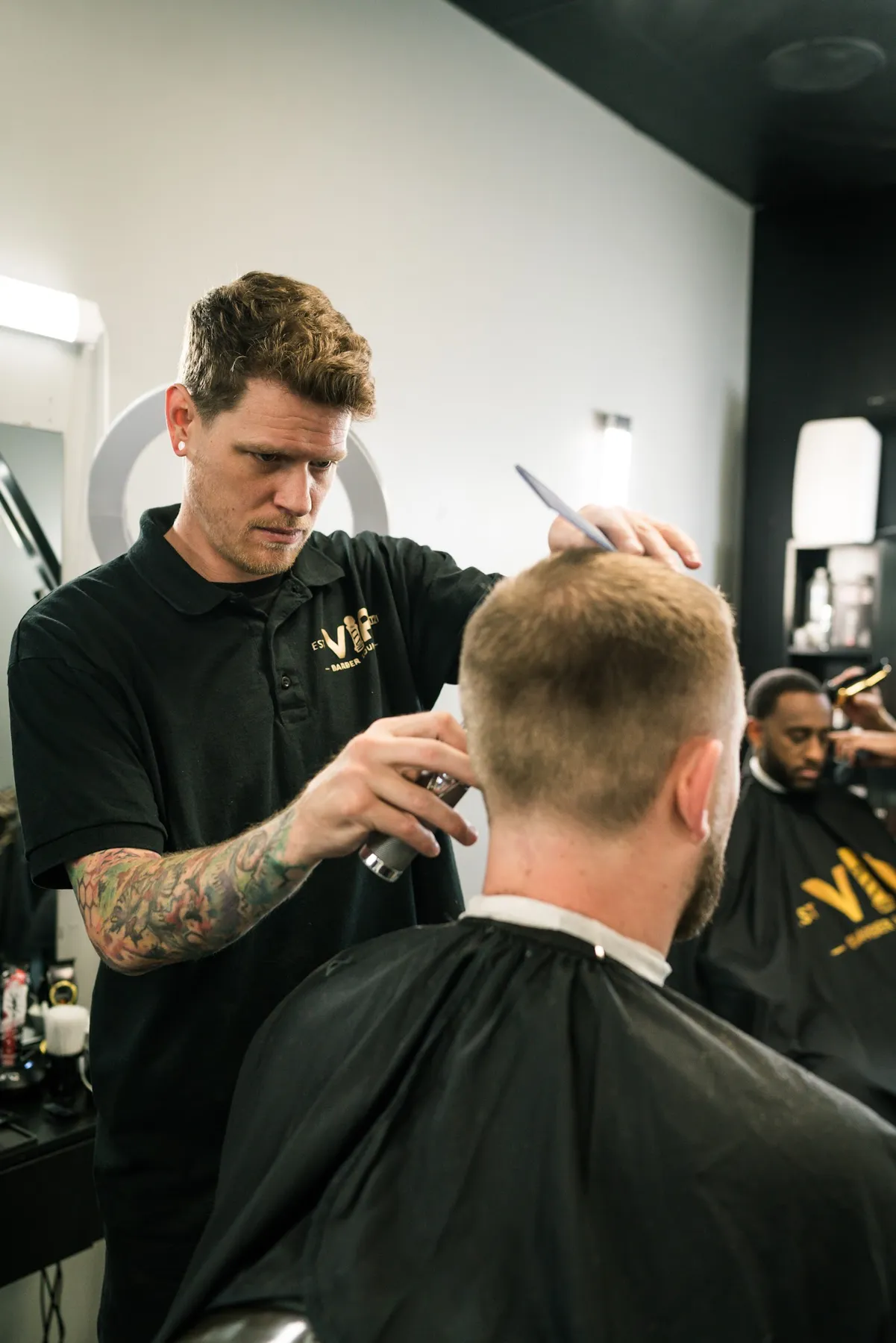 Barber blending a fade at VIP Barber Lounge South Aurora